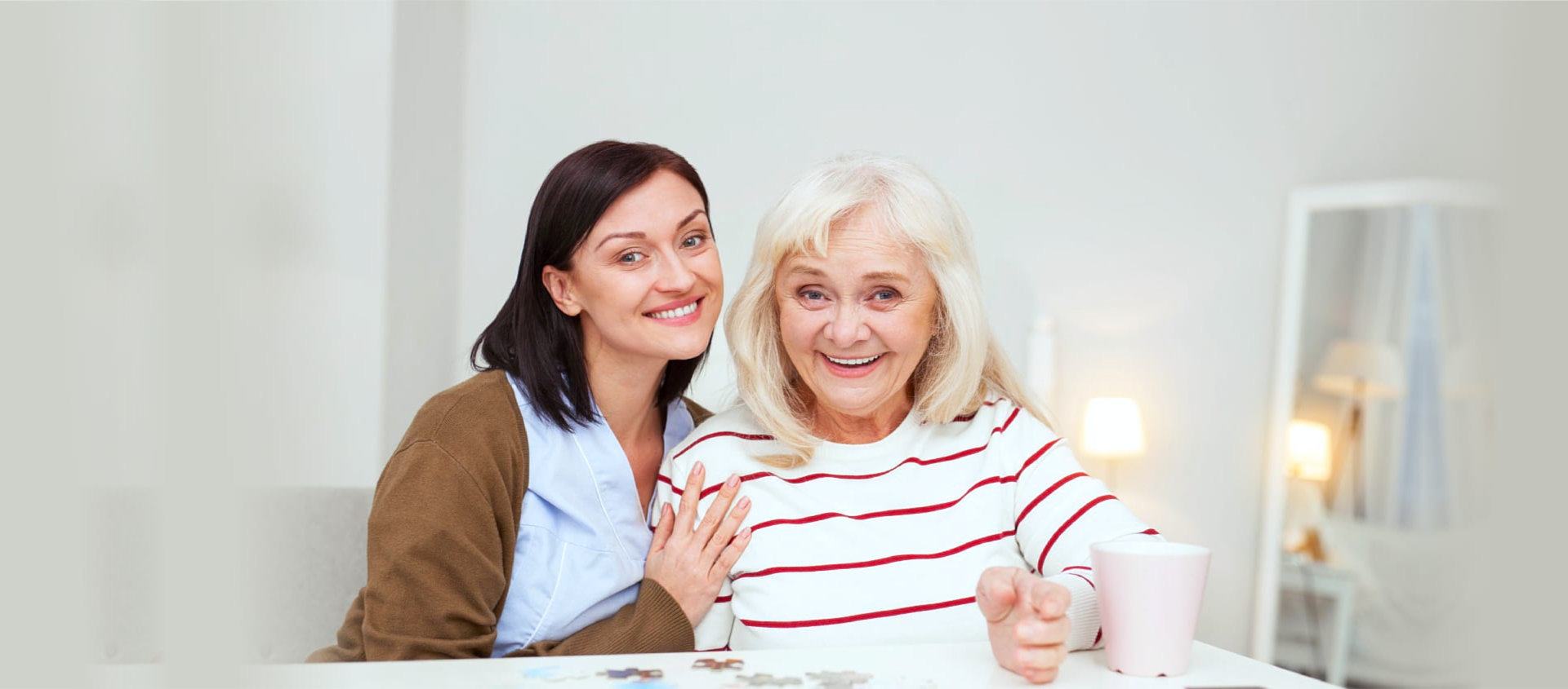 caregivers and elderly women smiling